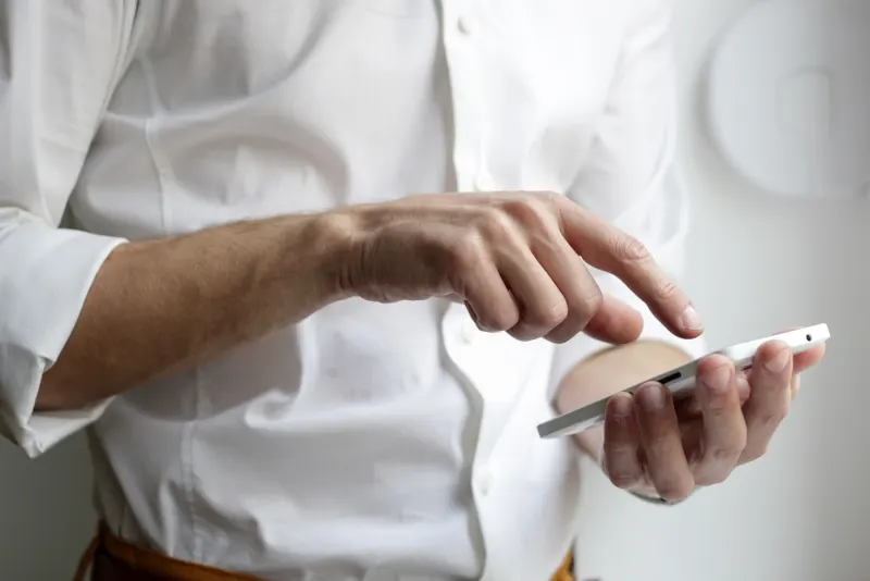 A person using a modern smartphone on an AT&T wireless plan